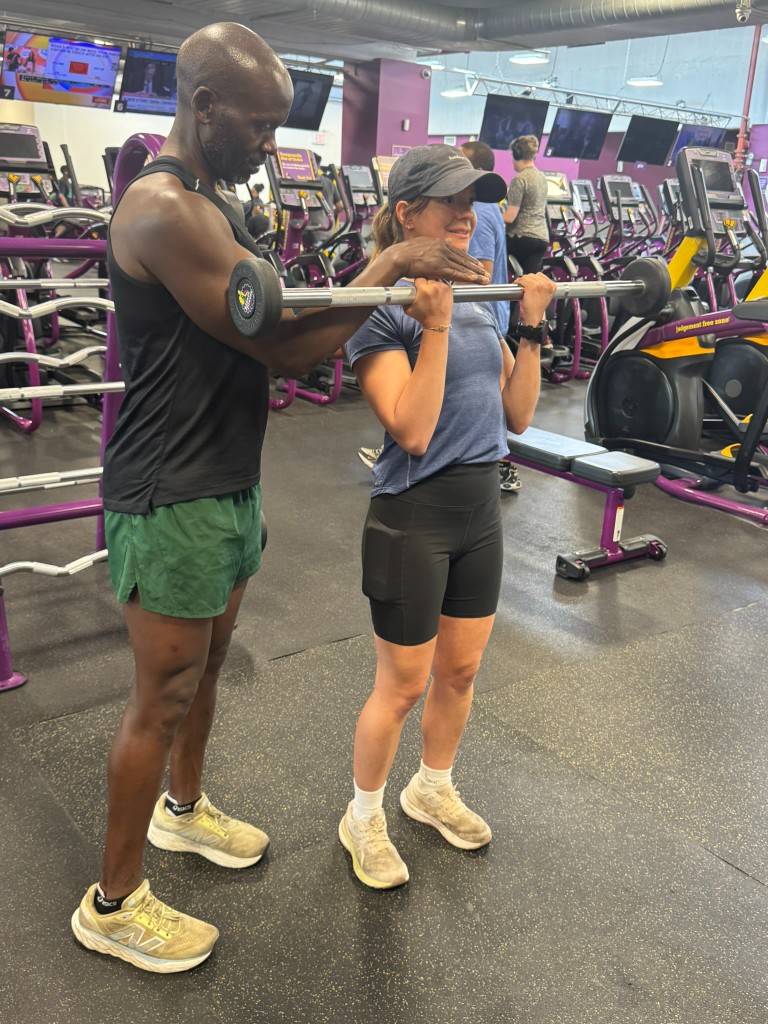 Patrick coaching a client in the gym